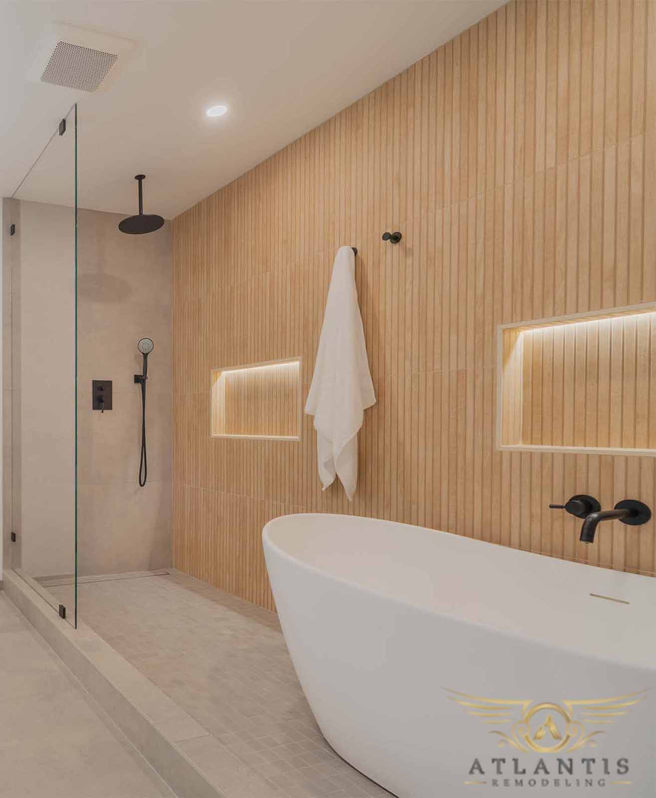 Spa-inspired master bathroom with wood slat accent wall and freestanding tub